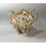 A mid 19th century vase with ornate decoration in polychrome and gilt, scroll and acanthus handles