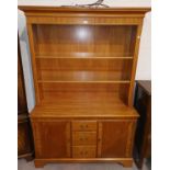 A light mahogany reproduction full height bookcase with open front, drawers and cupboard to base