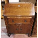 A 1920's golden oak fall front bureau with 3 drawers under
