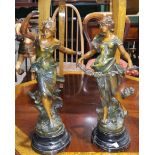 An Art Nouveau period pair of patinated spelter figures of young women after Auguste Moreau,