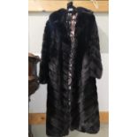 A full length mink coat in black stripe effect