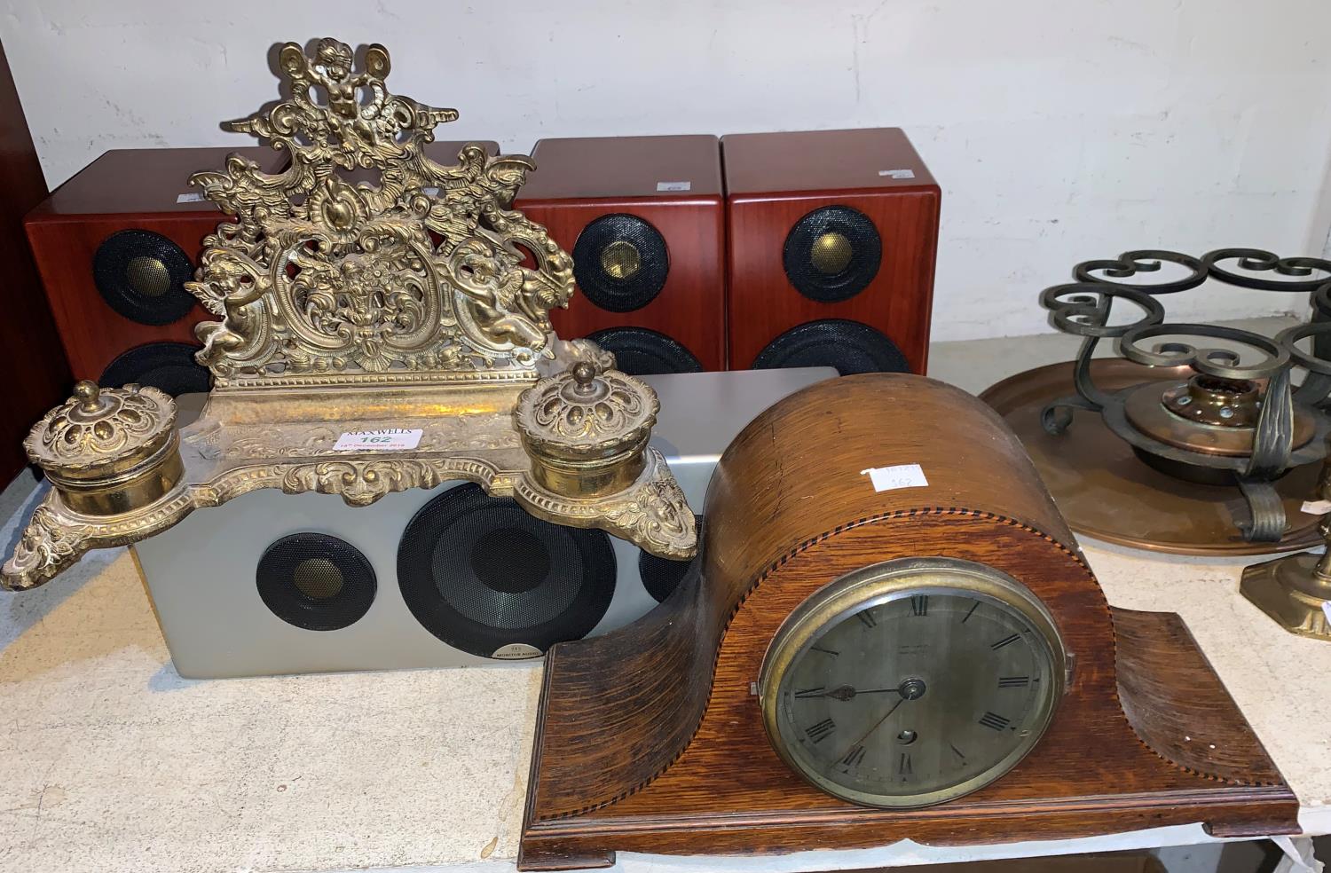 A brass desk organiser with letter rack and inkwell; an oak cased clock by Finnigan's of Manchester