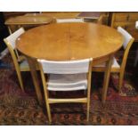 A circular 1960's teak dining table and 4 chairs
