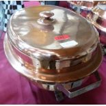 An ovoid copper and stainless steel lined chaffing dish with copper and tinned cover and stainless