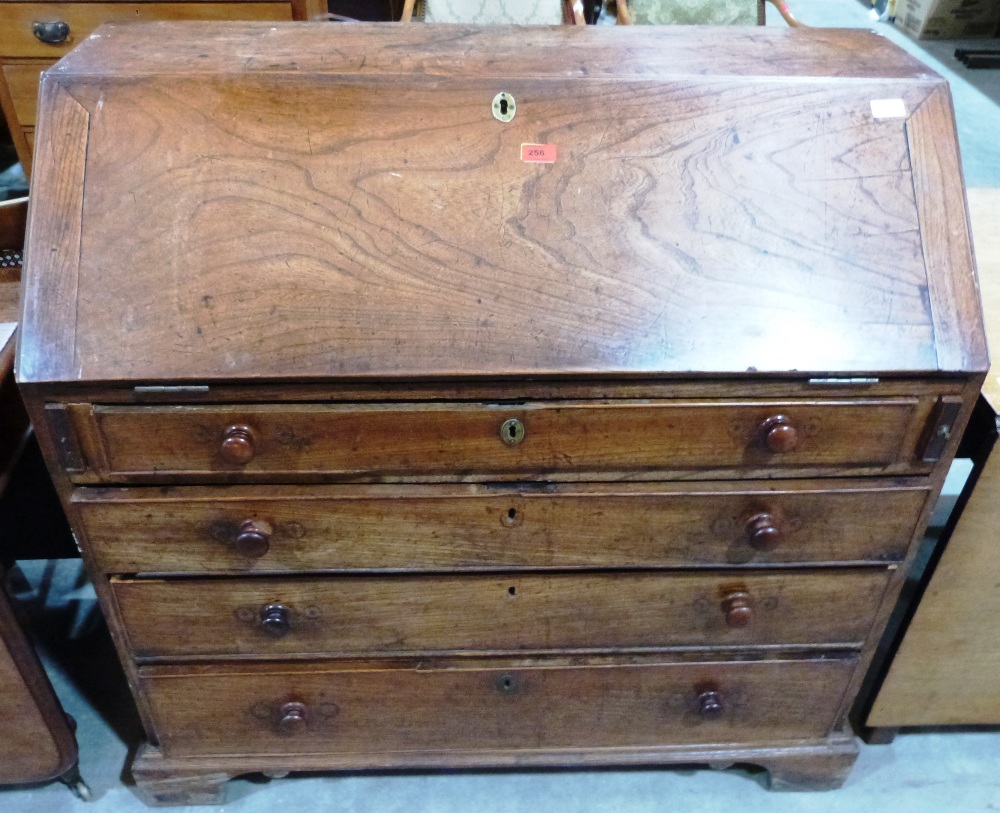 A George III elm bureau, the sloping fall over four long drawers. 40' wide