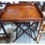 A 19th century mahogany butler's serving tray on folding stand. 24' wide