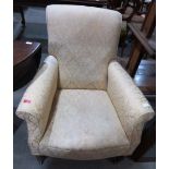 A Victorian upholstered armchair on turned legs and castors