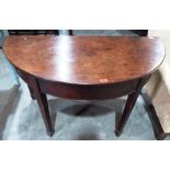 A George III mahogany gateleg supper table on square tapered legs with spade terminals. 48' wide