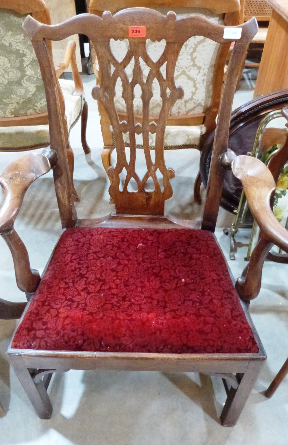 A George III mahogany 'Chippendale' elbow chair. Repairs