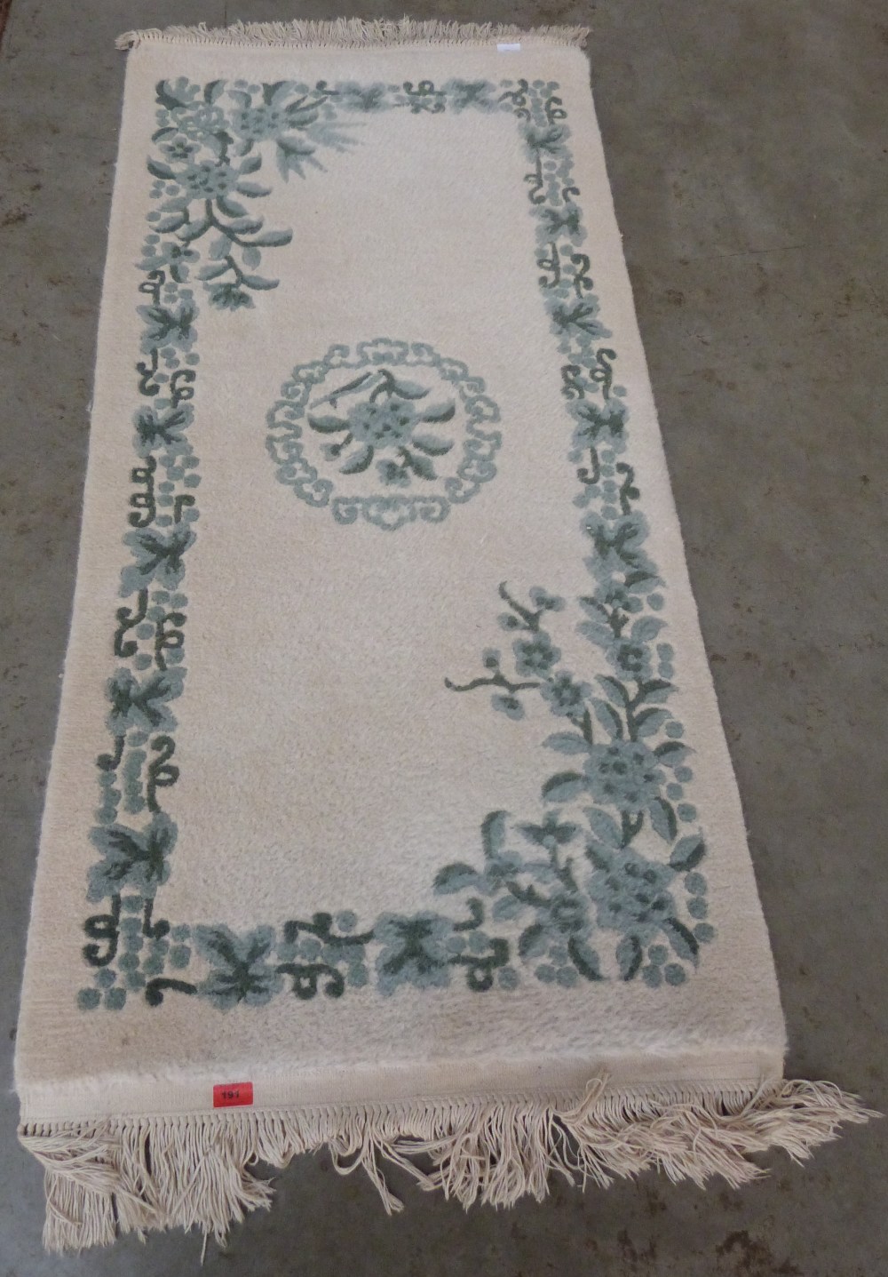 An Indian wool cream ground rug