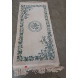 An Indian wool cream ground rug