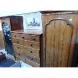 A Victorian pitch pine triple wardrobe, the centre part a chest of five short over two long and