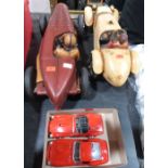 Two diecast Ferrari models and two resinous model cars