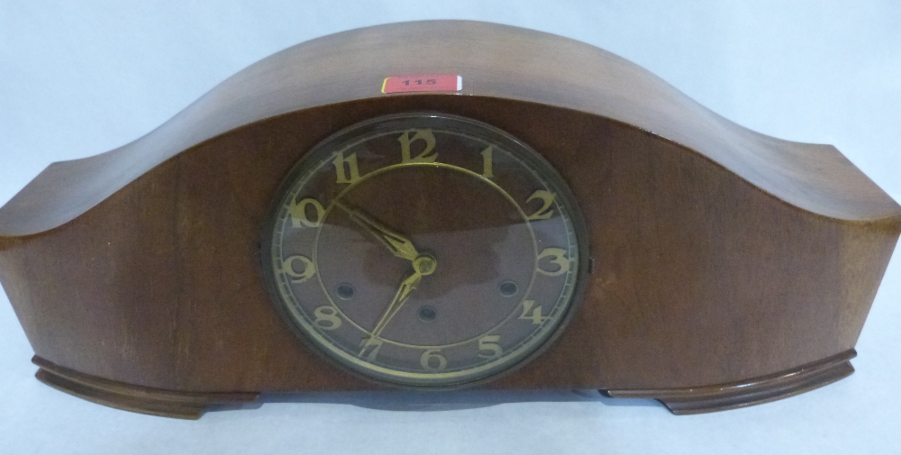 An Art Deco walnut mantle clock, the three train movement striking and chiming on five tubular