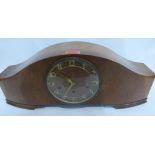 An Art Deco walnut mantle clock, the three train movement striking and chiming on five tubular