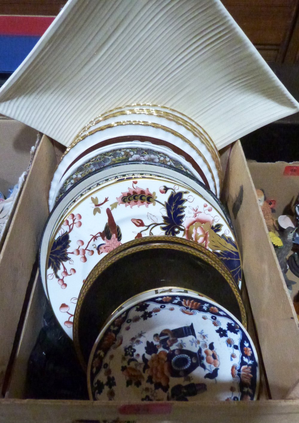 A box of miscellaneous decorated plates
