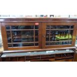 A Victorian mahogany dwarf bookcase enclosed by a pair of astragal glazed doors. 42' wide