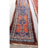 A tan and blue ground Eastern carpet runner. 120' x 36'