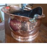 A copper helmet coal scuttle