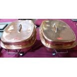 A pair of rectilinear copper and stainless steel lined chaffing dishes with copper and tinned covers