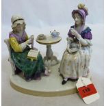 A continental porcelain group of two ladies sewing and taking tea. 7' high