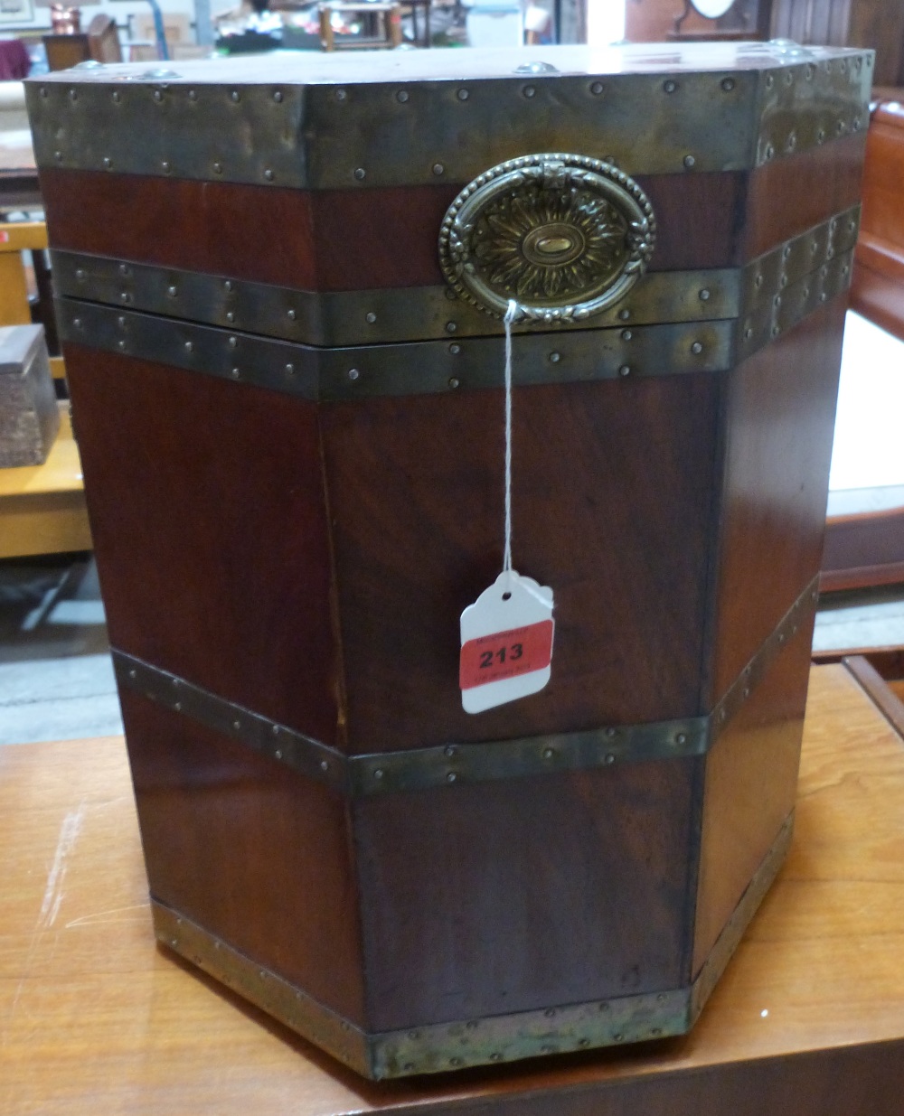 A mahogany octagonal cellarette with brass straps and ring patera handles. 16 1/2' high