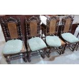 A set of four oak Carolean style chairs with caned backs and seats