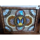 An inlaid tea tray set with butterfly wings under glass