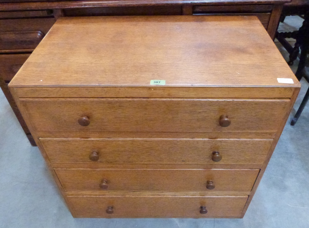An oak chest of four long drawers. 29½' wide