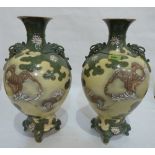 A pair of oriental relief decorated inverted baluster vases. 17½' high. Hair crack and repairs to