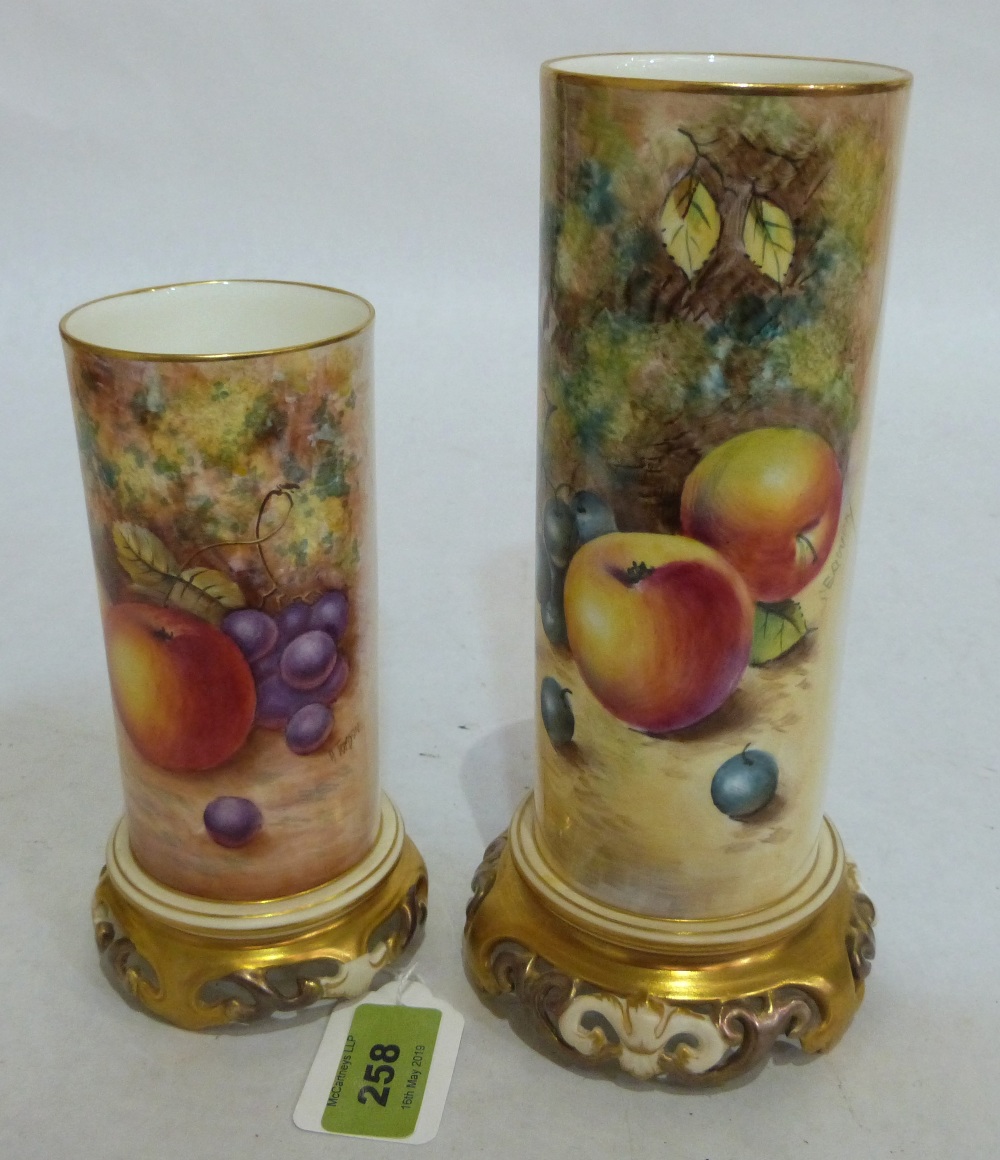 A pair of Royal Worcester graduated cylindrical vases, finely painted with fruit on a mossy bank, no