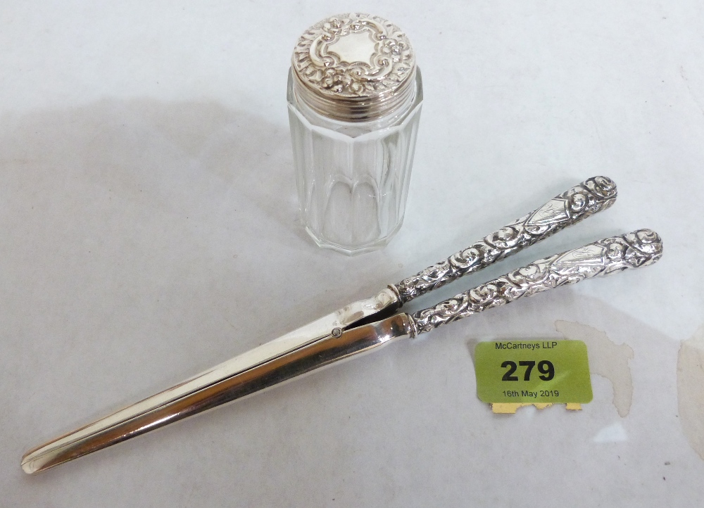 A pair of silver hafted glove stretchers and a silver topped dressing table jar