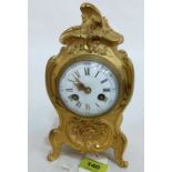 A 19th century French rococo revival ormolu bronze mantle clock, the enamel dial with Roman