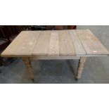 A Victorian pine extending dining table on turned legs, 60' long