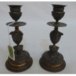 A pair of 19th century French bronzed metal candlesticks moulded with classical scenes. 7¼' high