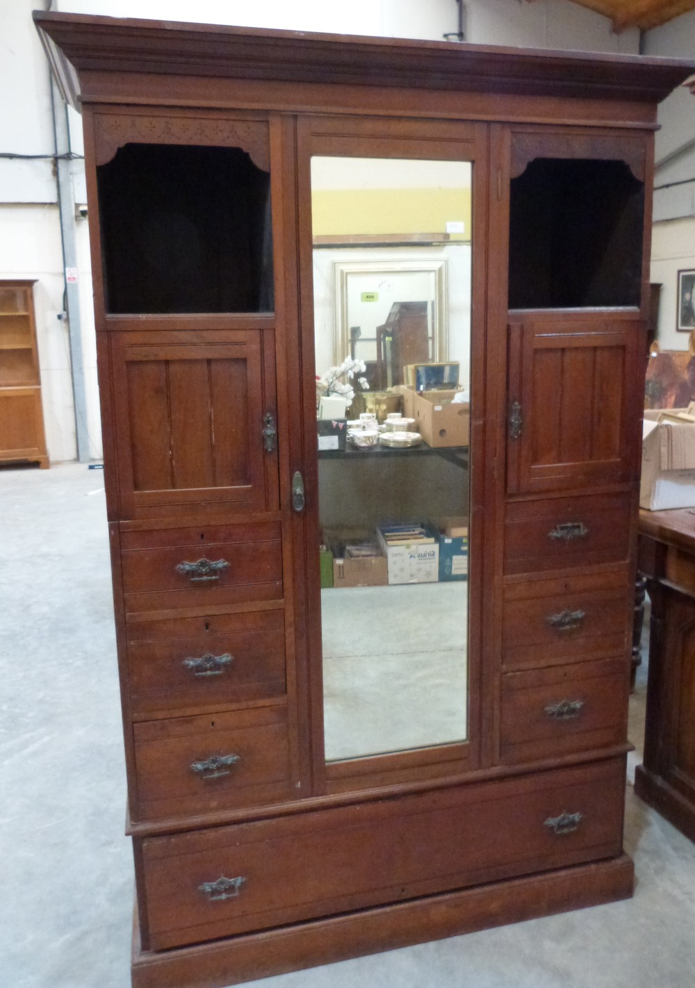 A late Victorian walnut wardrobe with mirror door and drawers flanking. 48' wide