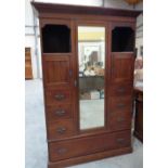 A late Victorian walnut wardrobe with mirror door and drawers flanking. 48' wide