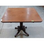 A Victorian mahogany snap-top table on ring turned column and quadripartite support. 30' wide