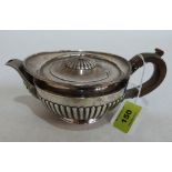 A Victorian silver half-gadrooned teapot of helmet form, stamped Dobson, Piccadilly London 1880.