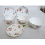 Colaport. Two large teacups and saucers, a sugar bowl and saucer, painted with flower sprays in