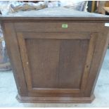 A 19th century oak hanging corner cupboard