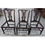 A set of three George III mahogany dining chairs. Drop-in seats lacking