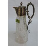 A cut glass claret jug with plated mounts and handle. 11¾' high