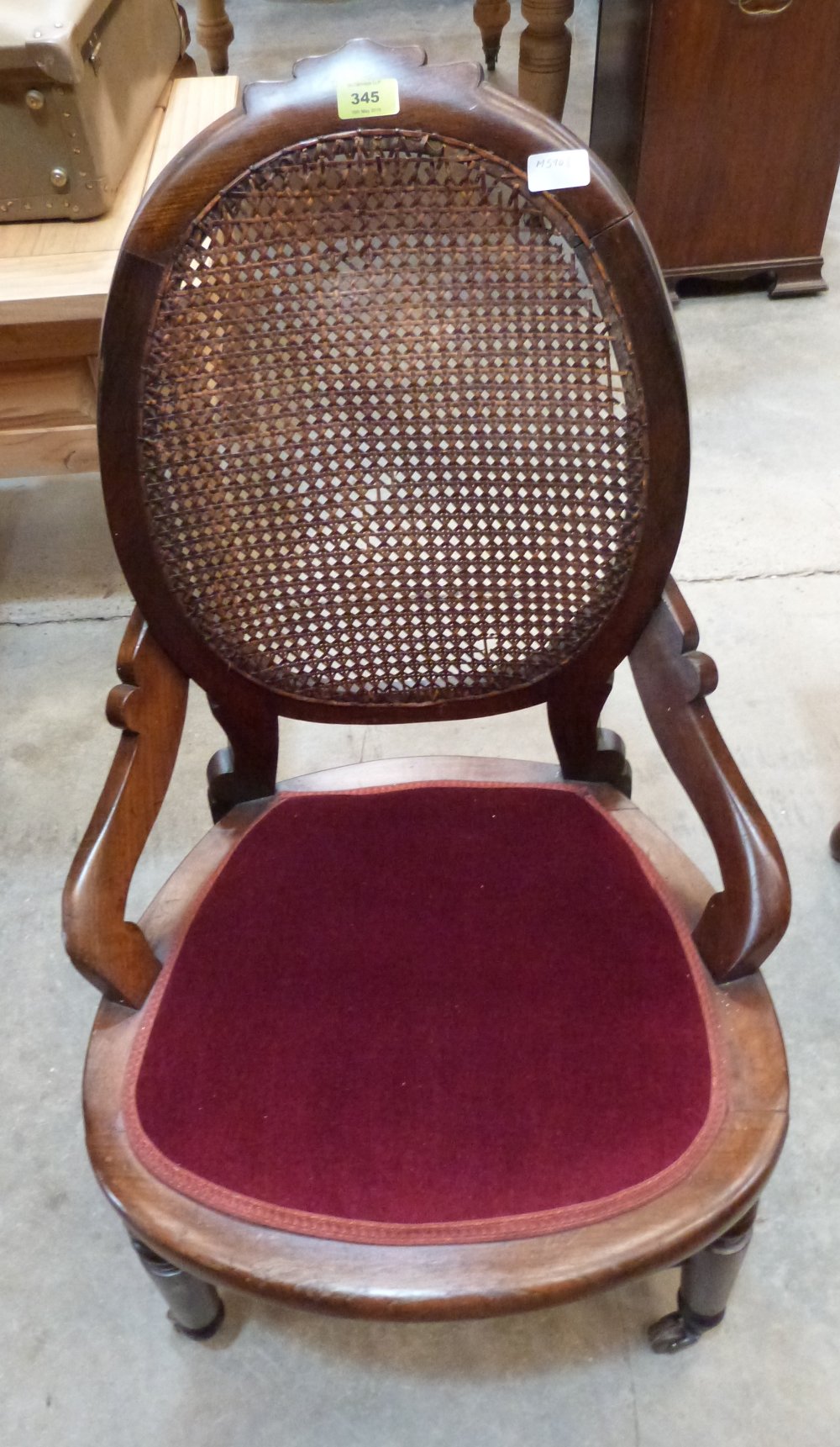 A Victorian walnut tub chair with oval caned back