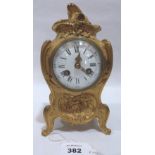 A 19th century French rococo revival ormolu bronze mantle clock, the enamel dial with Roman