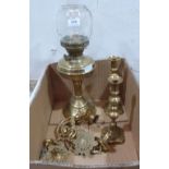 A brass oillamp, a pair of brass piano sconces and a pair of brass candlesticks