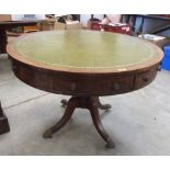 A Regency oak drum table, the inlet top over two real and six faux frieze drawers, on baluster