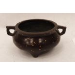 An oriental bronze censer with gold splashed decoration. Impressed character marks to base. 4'