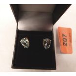 A pair of 9ct earrings set with pear shaped Topaz stones