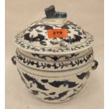 A Chinese blue and white jar and cover with bat and foliate decoration, the cover with dog finial.